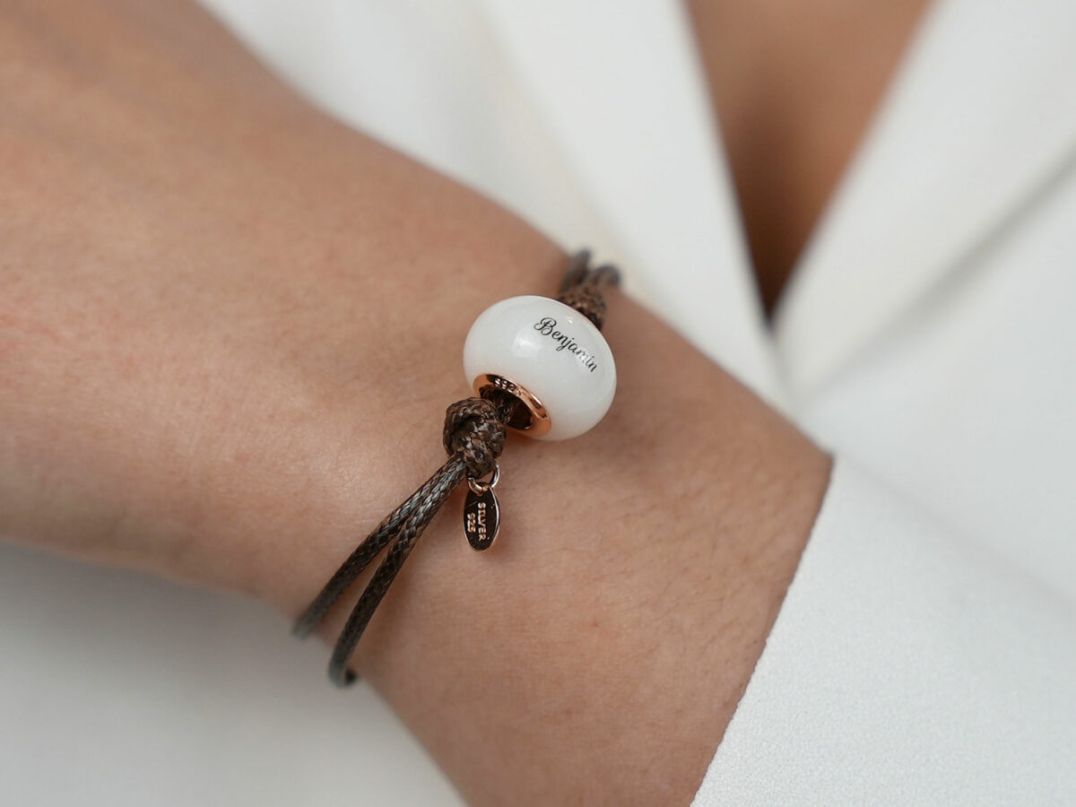 breastmilk jewelry bead bracelet with rose gold child's name from KeepsakeMom on a model wrist
