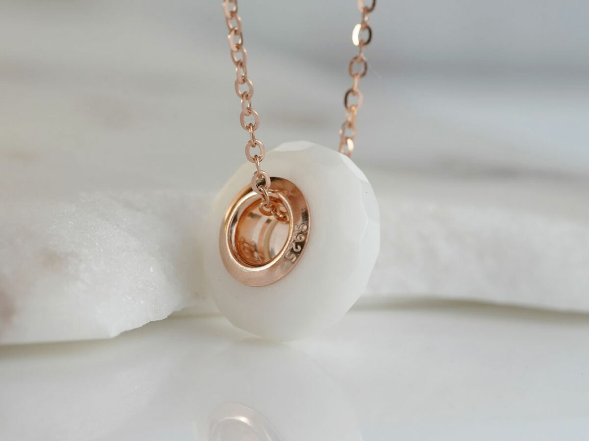 breastmilk jewelry faceted milk and honey honeycomb hexagon shape bead with rose gold keepsakemom on rose gold chain and white background