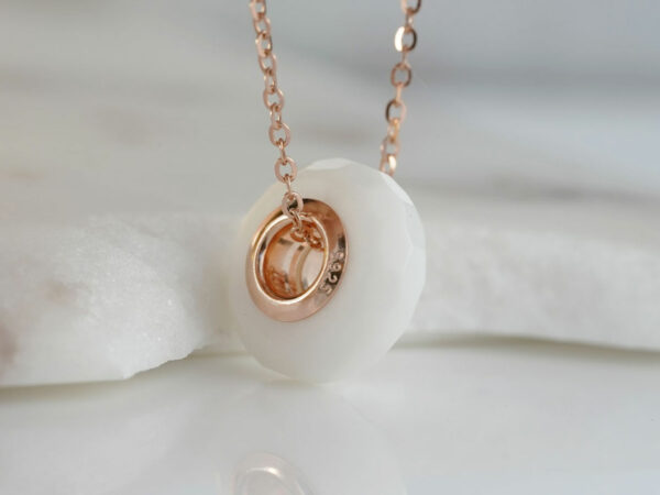 breastmilk jewelry faceted milk and honey honeycomb hexagon shape bead with rose gold keepsakemom on rose gold chain and white background