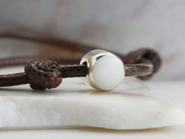 breastmilk jewelry bracelet with silver disc filled with breastmilk on a thick waxed brown cord for men from keepsakemom