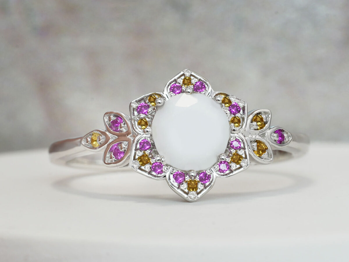 breast milk ring flower shaped white gold with citrine and alexandrite crystals on the side and central breast milk stone as a central diamond from keepsake mom