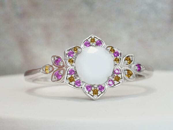 breast milk ring flower shaped white gold with citrine and alexandrite crystals on the side and central breast milk stone as a central diamond from keepsake mom