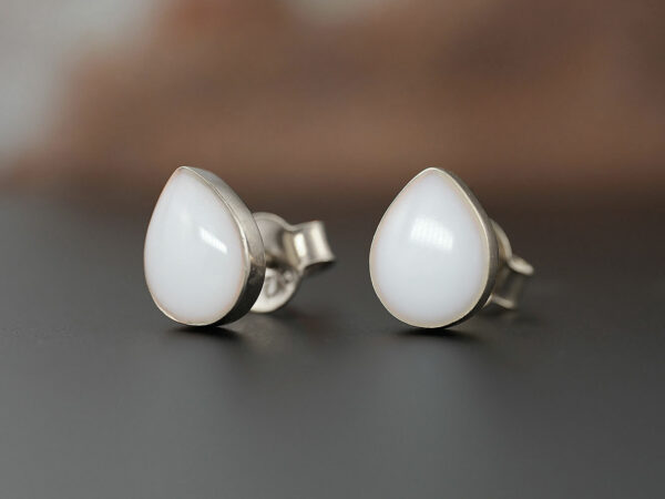 breastmilk pear teardrop shaped studded earrings from KeepsakeMom sterling silver on brown background simple