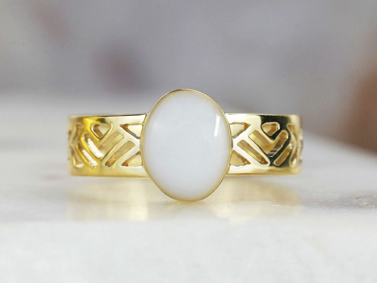 yellow gold plated sterling silver with negatively spaced rectangular slits in a thick band with an oval shaped breast milk stone from KeepsakeMom