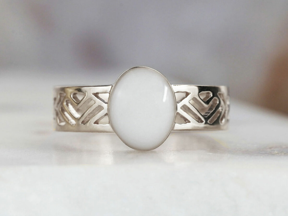 sterling silver with negatively spaced rectangular slits in a thick band with an oval shaped breast milk stone from KeepsakeMom