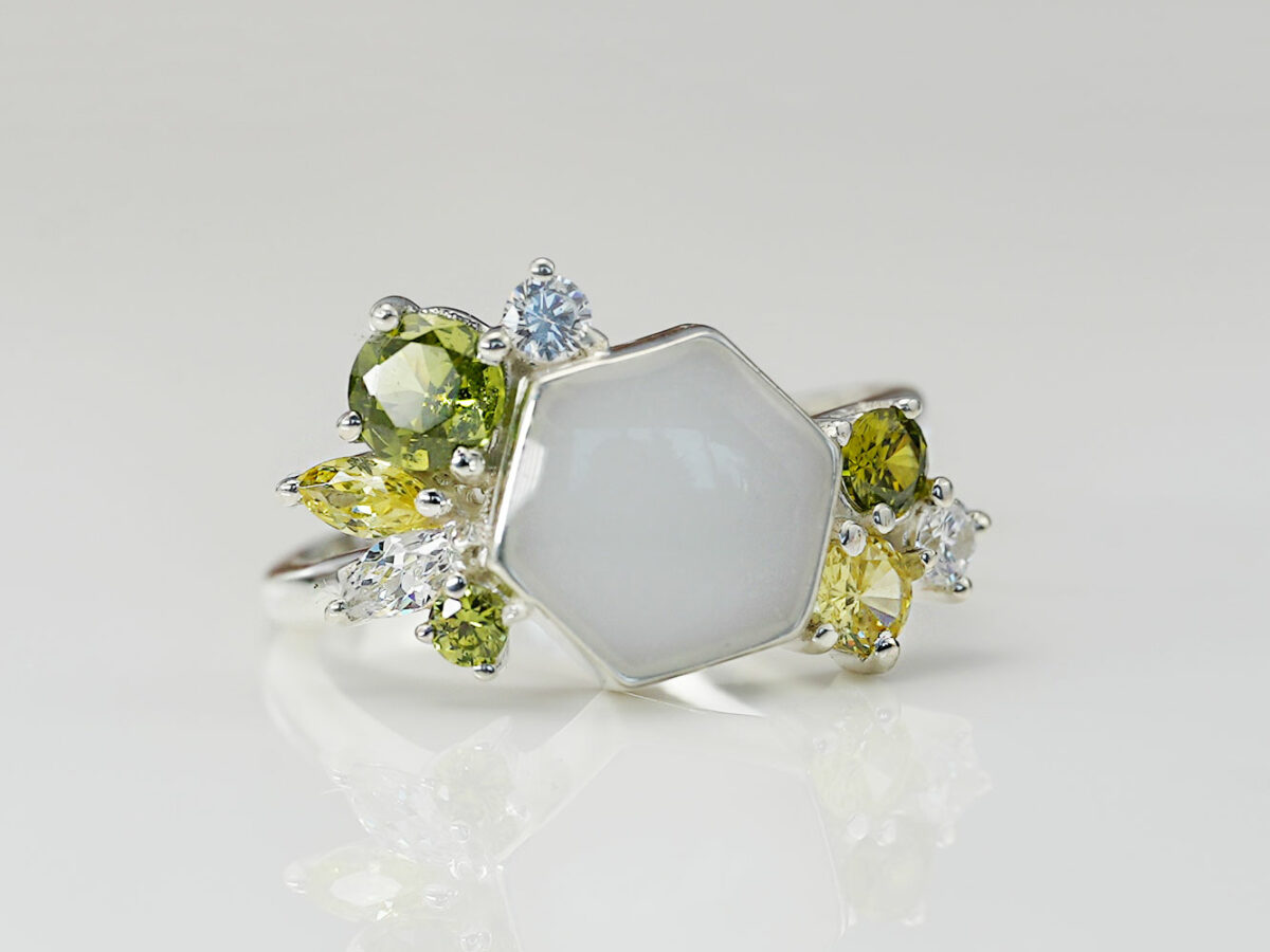 breastmilk ring in hexagon shape milk and honey with different birth month color crystals on each side from keepsakemom