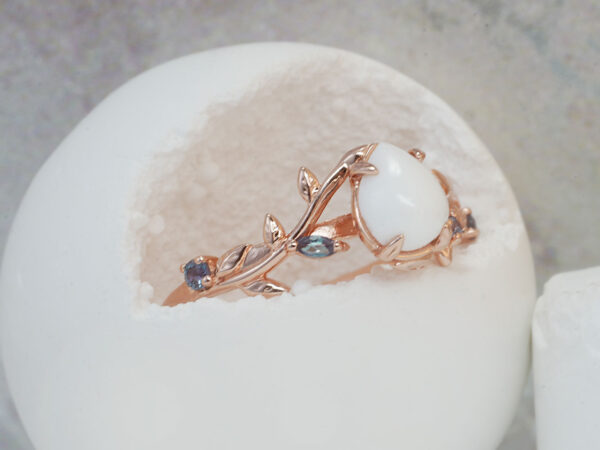 breastmilk jewelry from Keepsake Mom ring teardrop stone with rose gold setting leaves and crystals