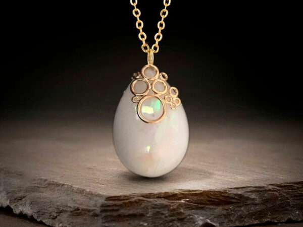 Breastmilk jewelry necklace pendant drop teardrop shape with opal effect flakes and fancy bail from KeepsakeMom yellow gold