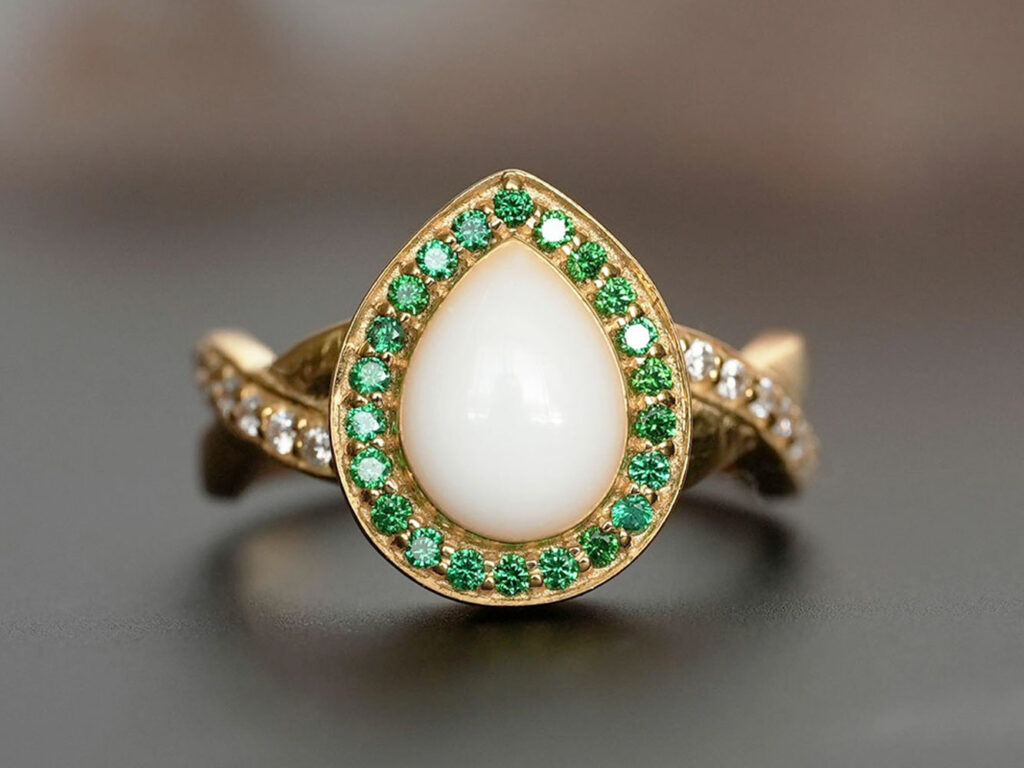 breastmilk jewelry ring with may green emerald May birth month color crystals around teardrop breastmilk stone from KeepsakeMom