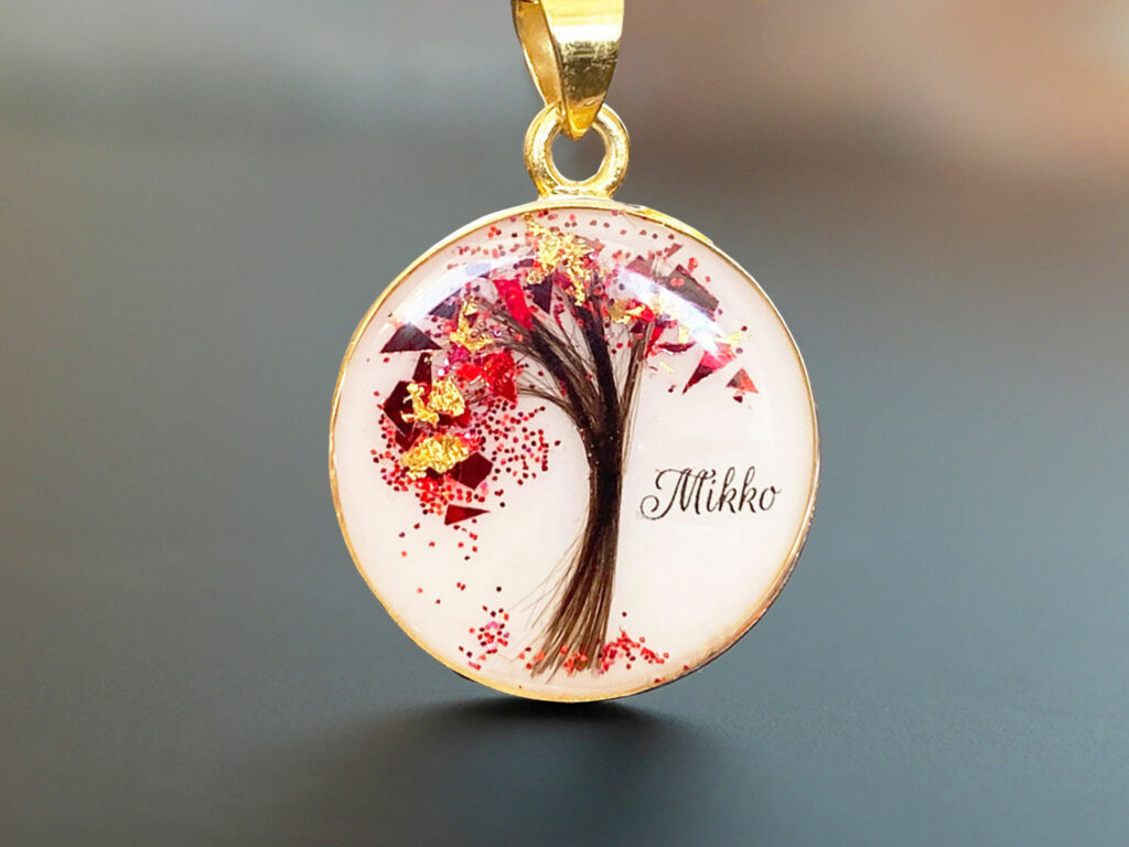 Breastmilk jewelry tree of life disc necklace with lock of hair and garnet January birth month color flakes as leaves from KeepsakeMom