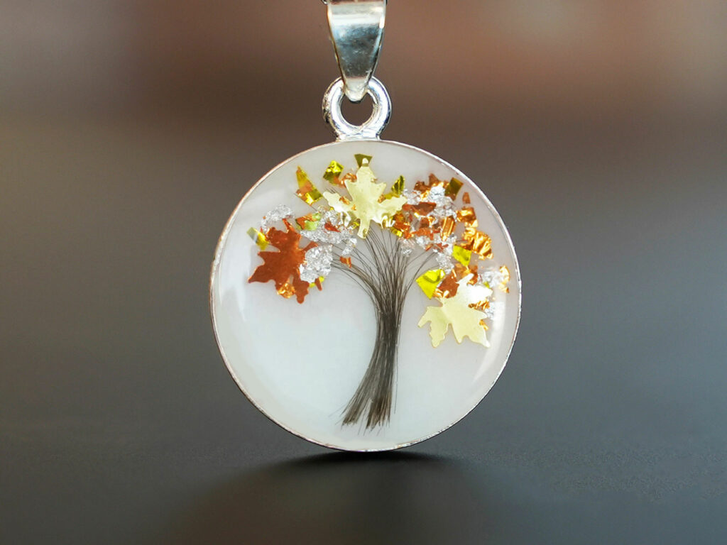 Breastmilk jewelry tree of life disc necklace with lock of hair and yellow citrine November birth month color flakes as leaves from KeepsakeMom