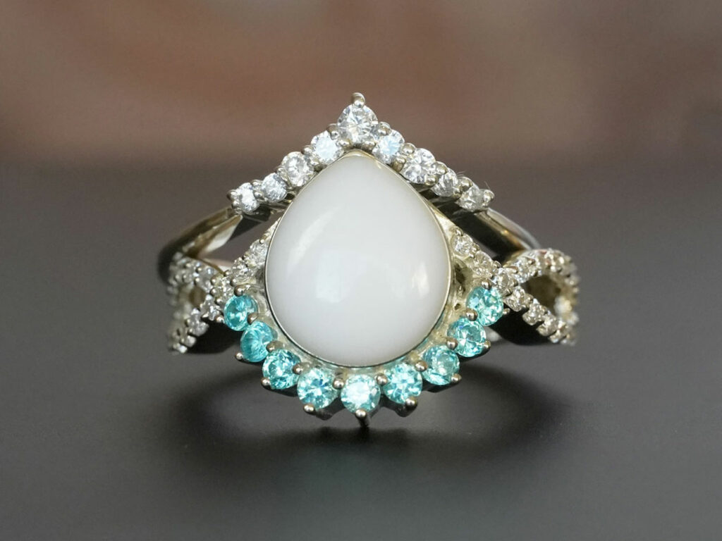 breastmilk jewelry ring set with blue aquamarine March birth month color crystals around teardrop breastmilk stone from KeepsakeMom