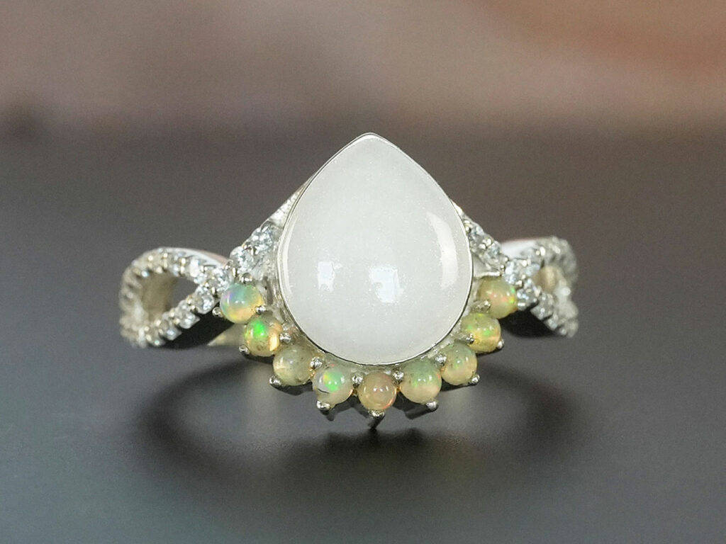 breastmilk jewelry ring with opal October birth month color crystals around teardrop breastmilk stone from KeepsakeMom