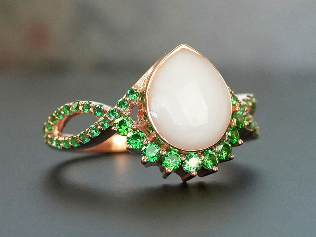 breastmilk jewelry ring with may green emerald May birth month color crystals around teardrop breastmilk stone from KeepsakeMom