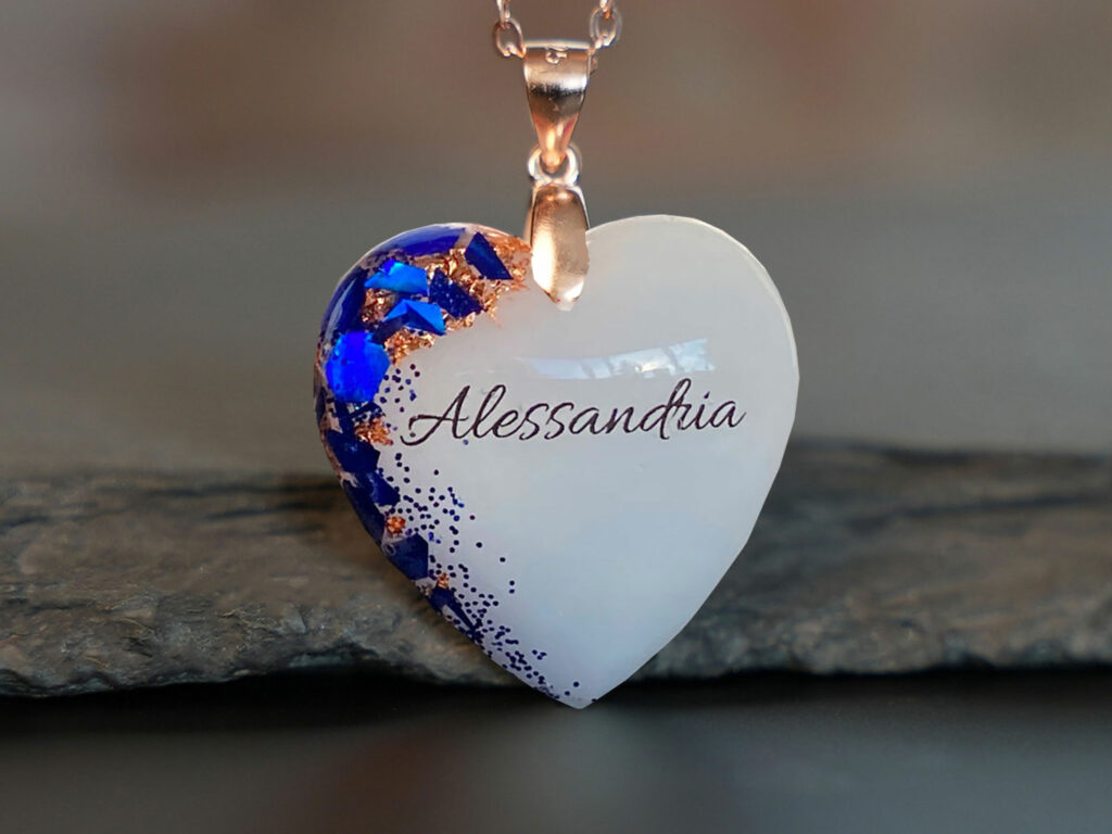 Breastmilk jewelry rose gold heart necklace with blue tanzanite December birth month color flakes and baby's name from KeepsakeMom