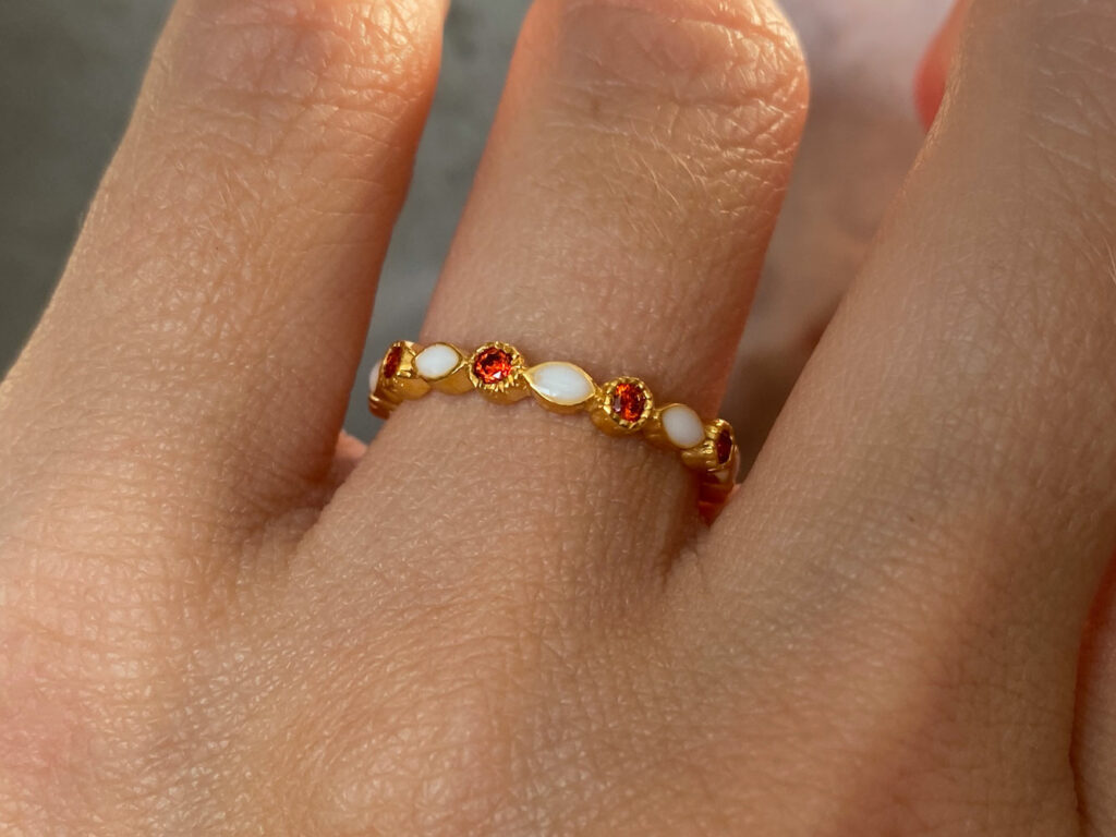 Breastmilk jewelry fine band infinity marquise style ring with garnet January birth month color crystals or real gems from KeepsakeMom hand model