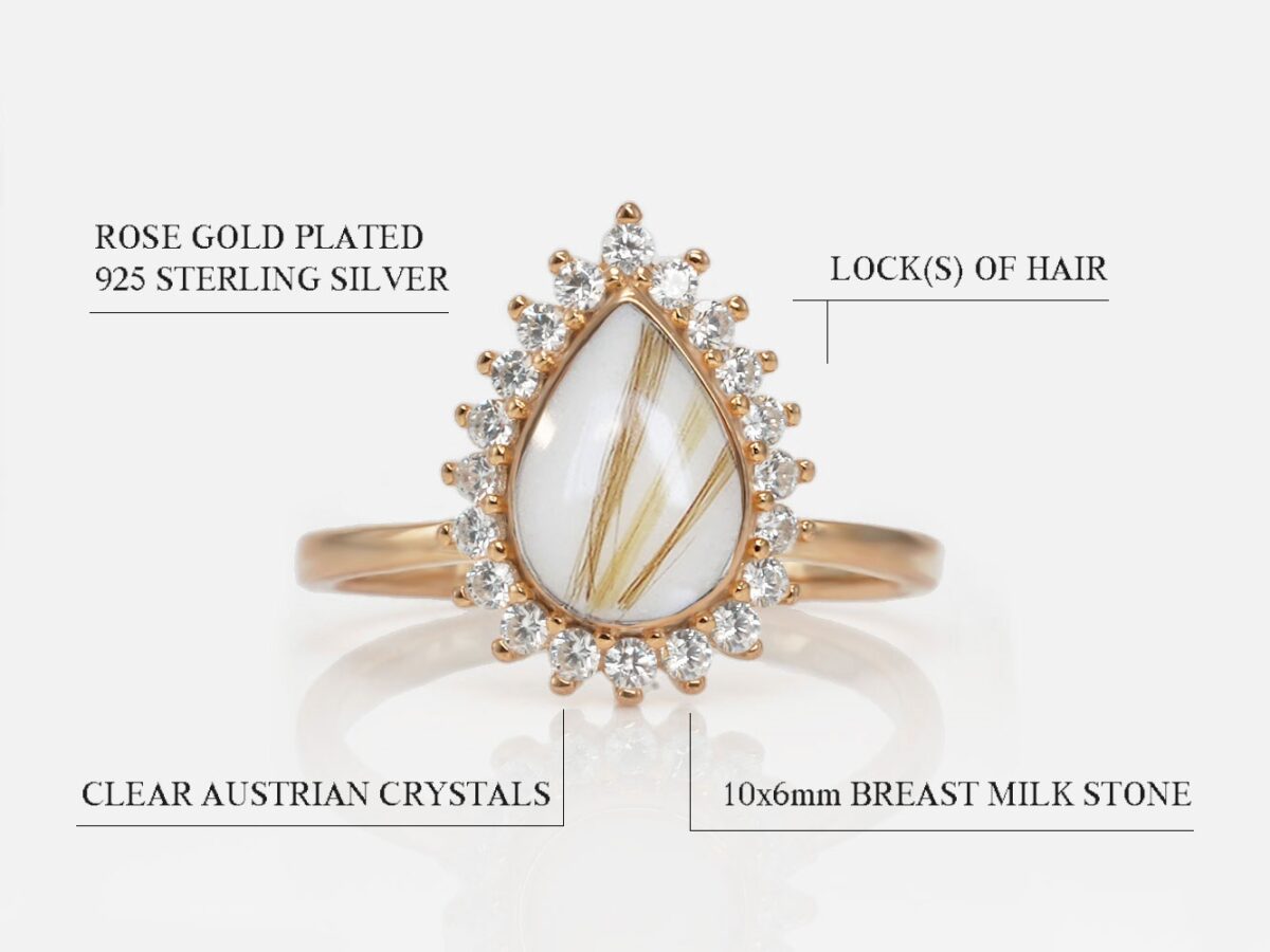breast milk ring in rose gold teardrop shape with three lines of locks of hair and crystals around the breast milk stone on white background from keepsakemom