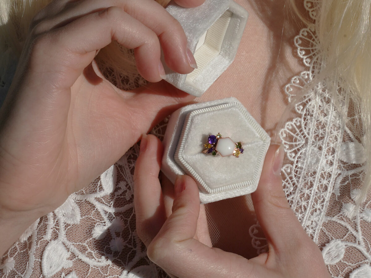 breastmilk jewelry ring in the box showing model in white dress from KeepsakeMom