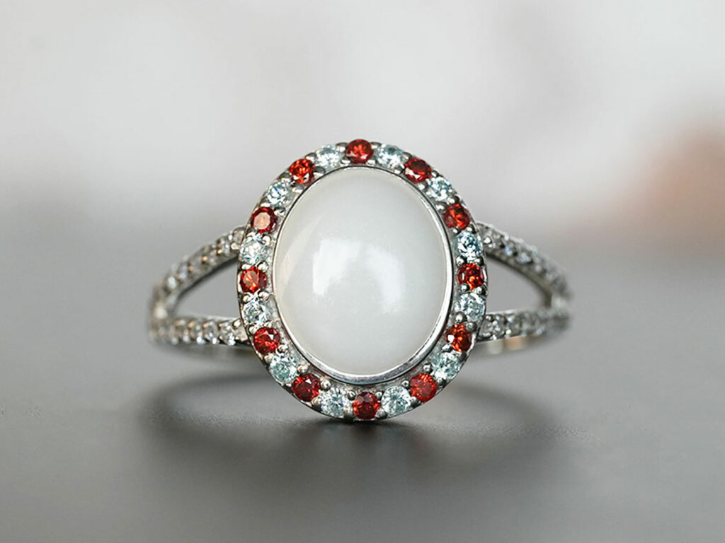 breastmilk jewelry ring with garnet red January birth month color crystals around oval breastmilk stone from KeepsakeMom