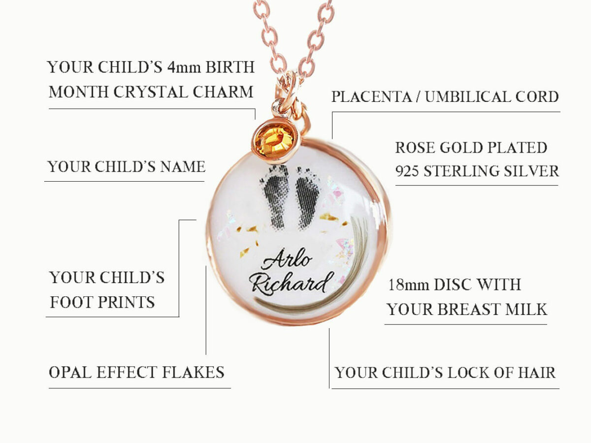 breast milk disc round shaped necklace with baby foot prints, lock of hair, placenta specks, opal flakes and orange dangle in rose gold setting on white background describing features diagram from keepsakemom