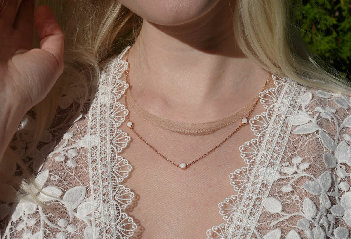 breastmilk jewelry necklace model in white dress from KeepsakeMom