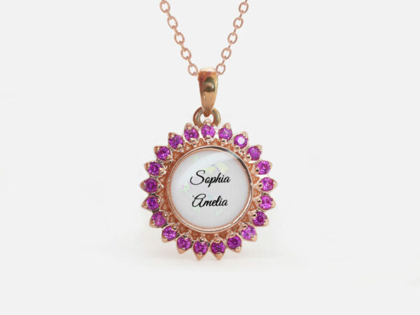 breastrmilk jewelry disc necklace flower sun birth month color crystals KeepsakeMom custom pink ruby crystals around breastmilk round stone in the center with name on white background