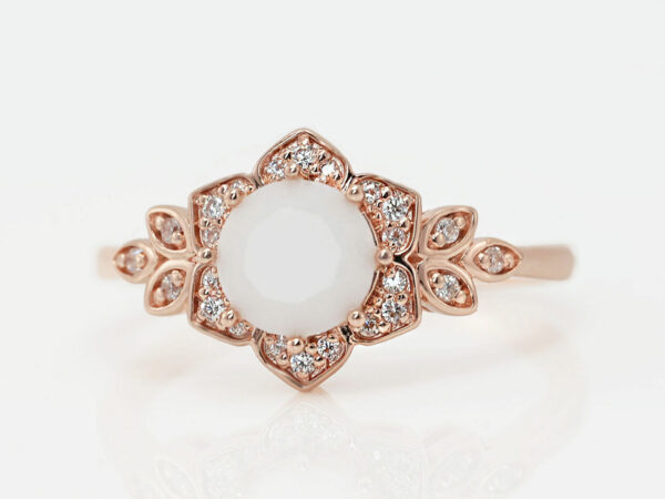 breast milk ring flower shaped rose gold with clear crystals on the side and central breast milk stone as a central diamond from keepsake mom