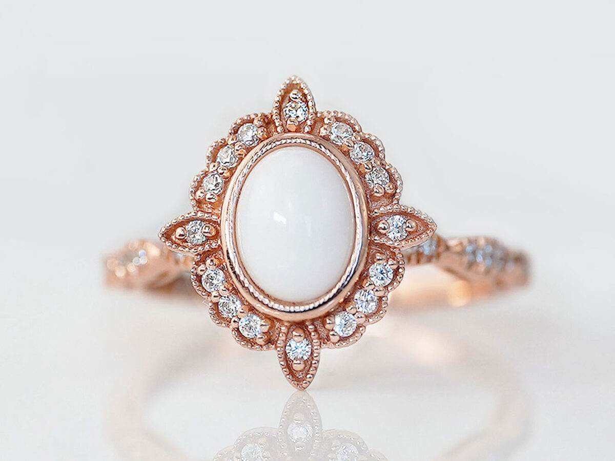 breast milk ring oval shaped rose gold with clear crystals on around central breast milk stone as a central oval stone from keepsakemom