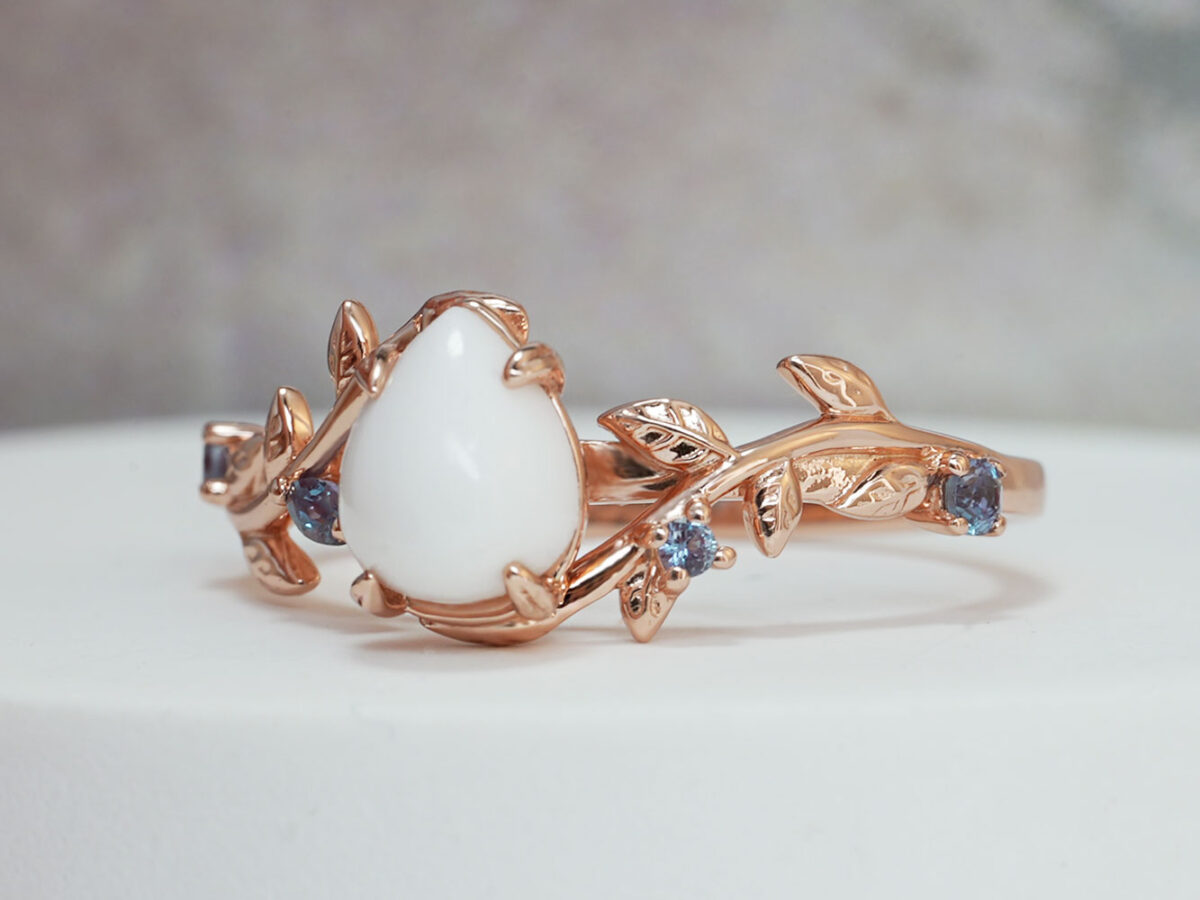 breastmilk jewelry from Keepsake Mom ring teardrop stone with rose gold setting leaves and crystals