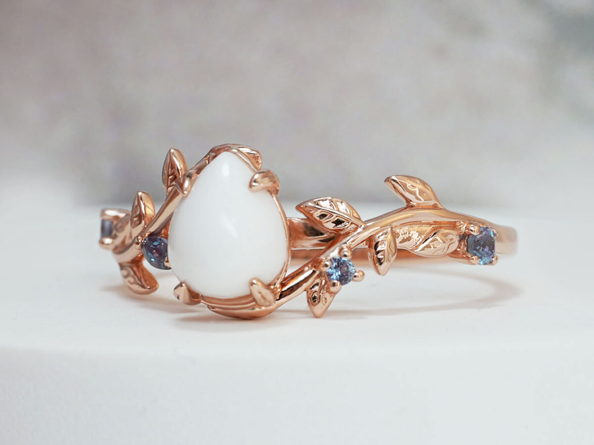 breastmilk jewelry from Keepsake Mom ring teardrop stone with rose gold setting leaves and crystals