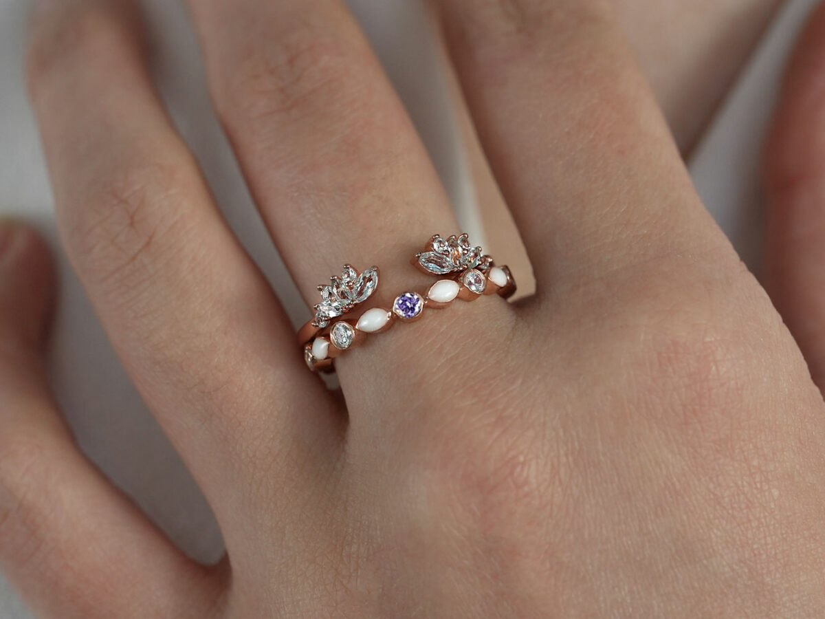 breast milk ring set fine bands rose gold plated and central amethyst gem from keepsakemom on a hand model