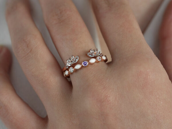breast milk ring set fine bands rose gold plated and central amethyst gem from keepsakemom on a hand model