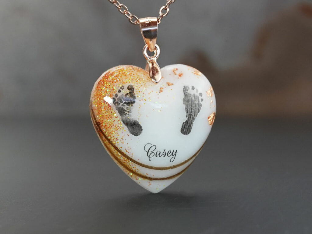 breastmilk jewelry heart necklace with November birth month yellow citrine stone color shimmers and flakes, foot prints, name and hair from KeepsakeMom