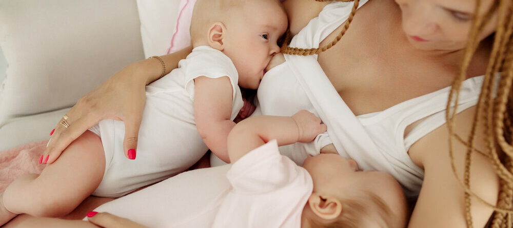 Mother breastfeeding twins