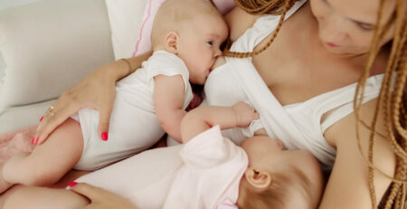 Mother breastfeeding twins