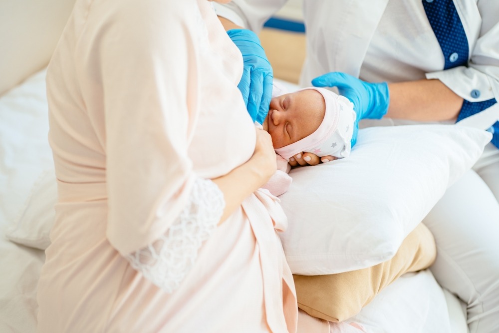 Lactation consultant helping a newborn latch