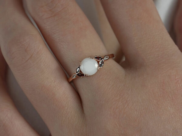 breastmilk ring diamond shaped stone leaves crystals on each side in birth month colors red and blue from Keepsakemom rose gold model hand