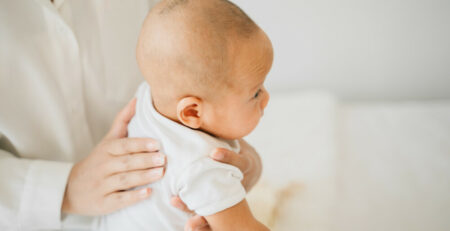 Mom burping a newborn on her lap