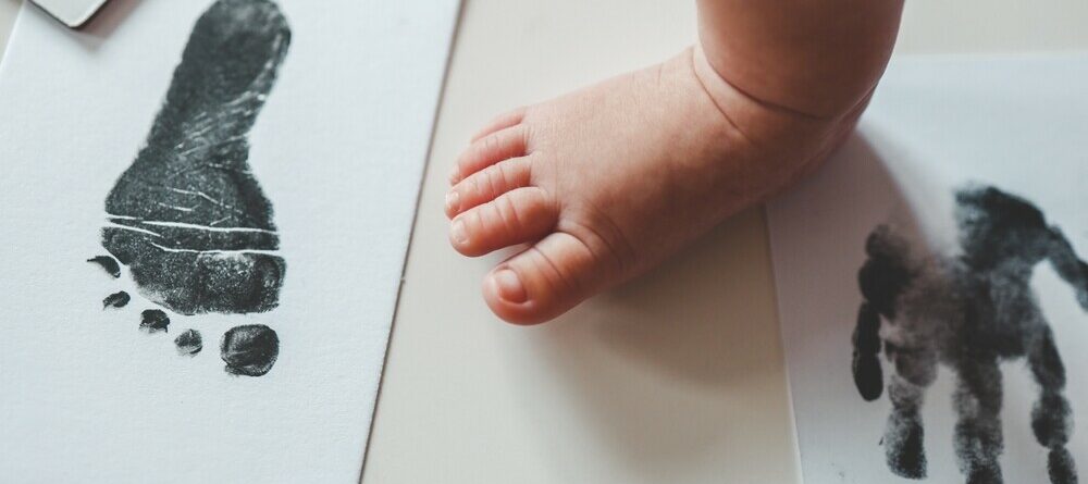 Baby footprint on white paper