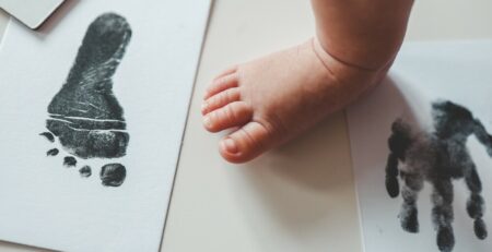 Baby footprint on white paper