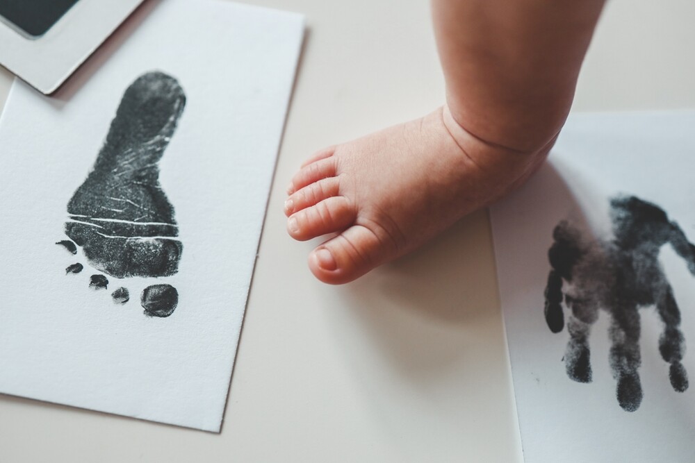 Baby footprint on white paper