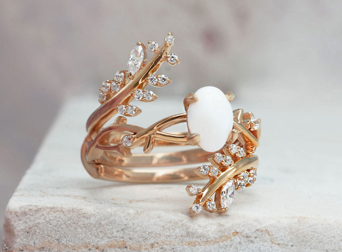 breastmilk jewelry two rings set in gold plated rose gold over sterling silver with central small oval milk stone and leaf branches fanning out on the outer ring from KeepsakeMom