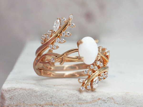 breastmilk jewelry two rings set in gold plated rose gold over sterling silver with central small oval milk stone and leaf branches fanning out on the outer ring from KeepsakeMom
