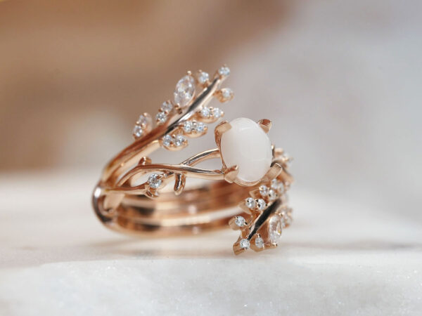breastmilk jewelry two rings set in gold plated rose gold over sterling silver with central small oval milk stone and leaf branches fanning out on the outer ring from KeepsakeMom