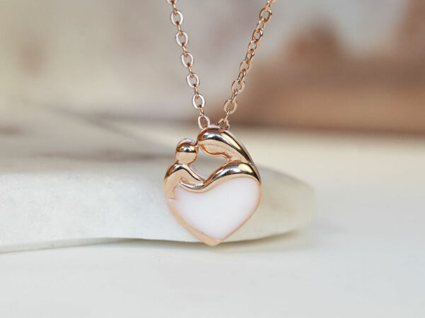 breastmilk jewelry heart necklace with mother and baby outline filled with breastmilk in rose gold setting from keepsakemom