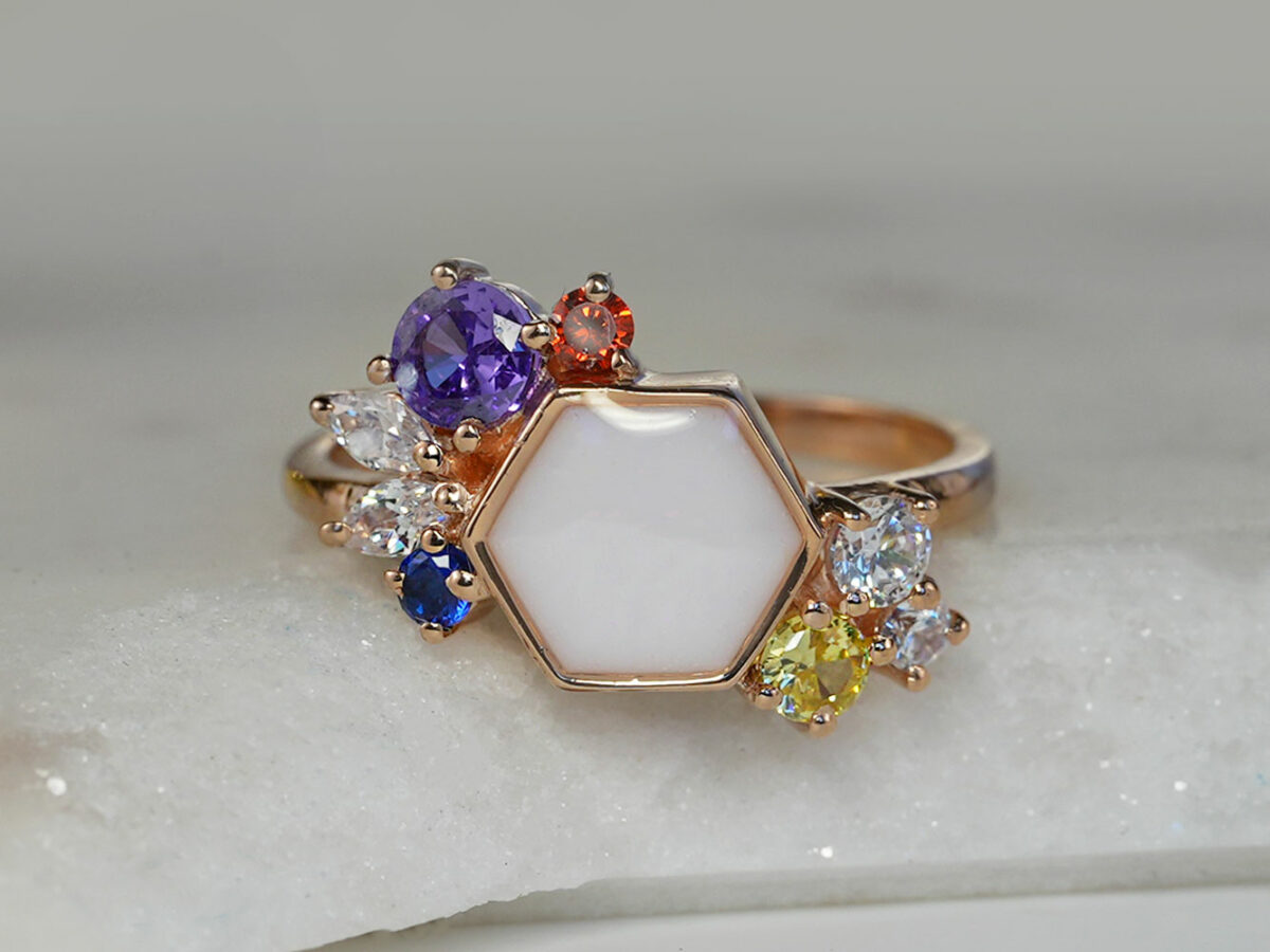 breastmilk ring in hexagon shape milk and honey with different birth month color crystals on each side from keepsakemom