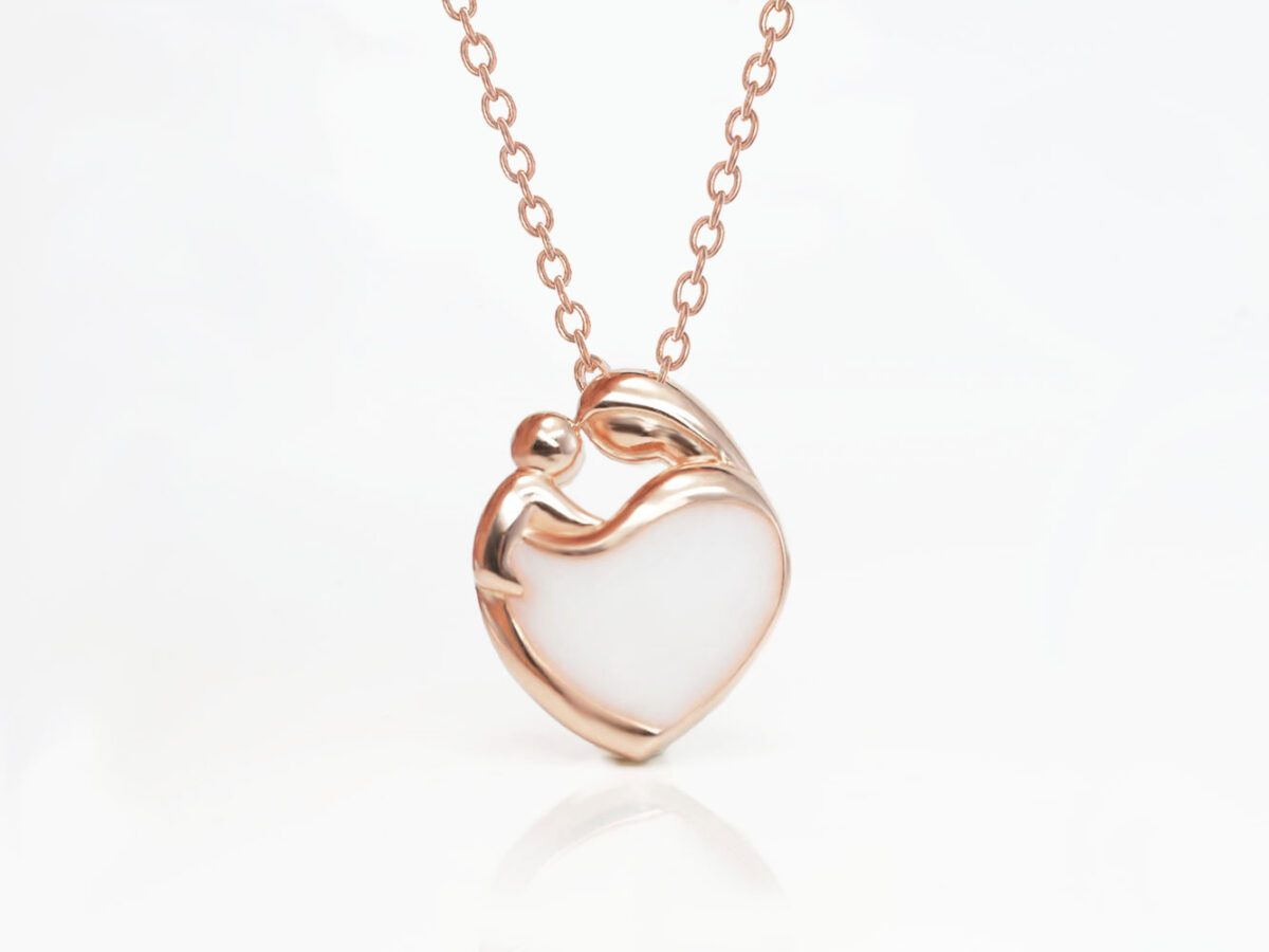 breastmilk jewelry heart necklace with mother and baby outline filled with breastmilk in rose gold setting from keepsakemom on white background