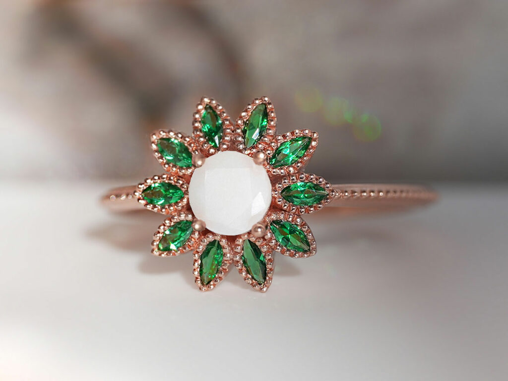 breastmilk jewelry rose gold flower shaped ring with may emerald birth month color crystals gems around breastmilk central stone from keepsakemom