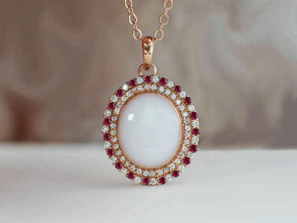 breastrmilk jewelry oval necklace with double halo of birth month color crystals from KeepsakeMom in rose gold with clear and red crystals alternating