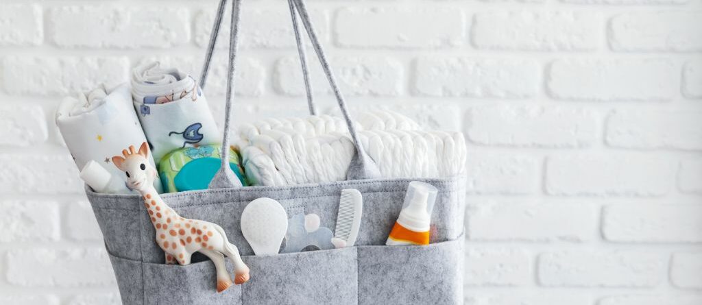 Mom holding a diaper bag filled with newborn essentials